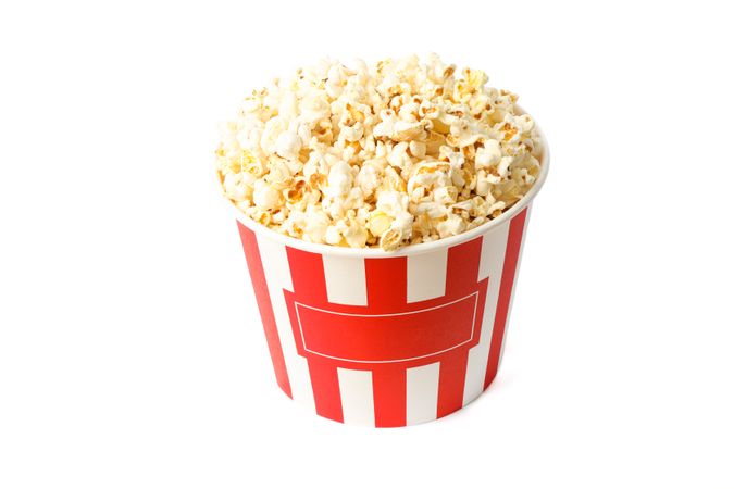 Striped bucket with popcorn isolated on blank background