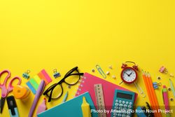Flat lay of colorful stationary on yellow table 5pJ8wb