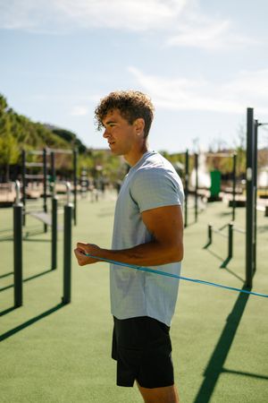 Strong young sportsman doing calisthenics