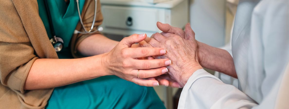 Doctor giving encouragement to mature patient