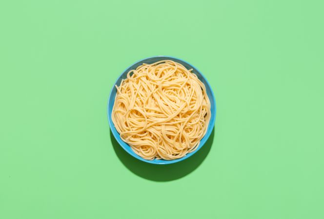Spaghetti top view on a green background