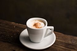 Cups of tasty hot coffee drink on wooden table