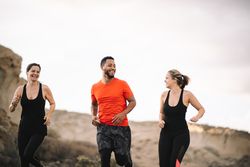 Multiracial friends jogging on nature together