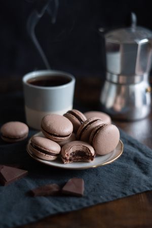French chocolate macarons served with coffee in mug