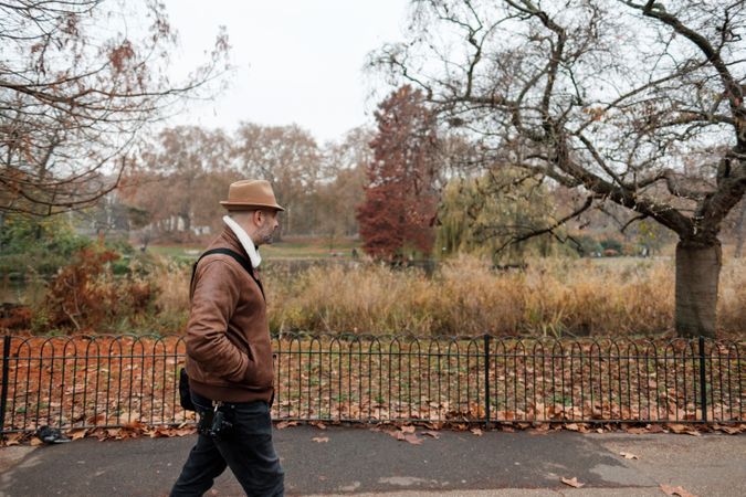 Relaxed man walking near park