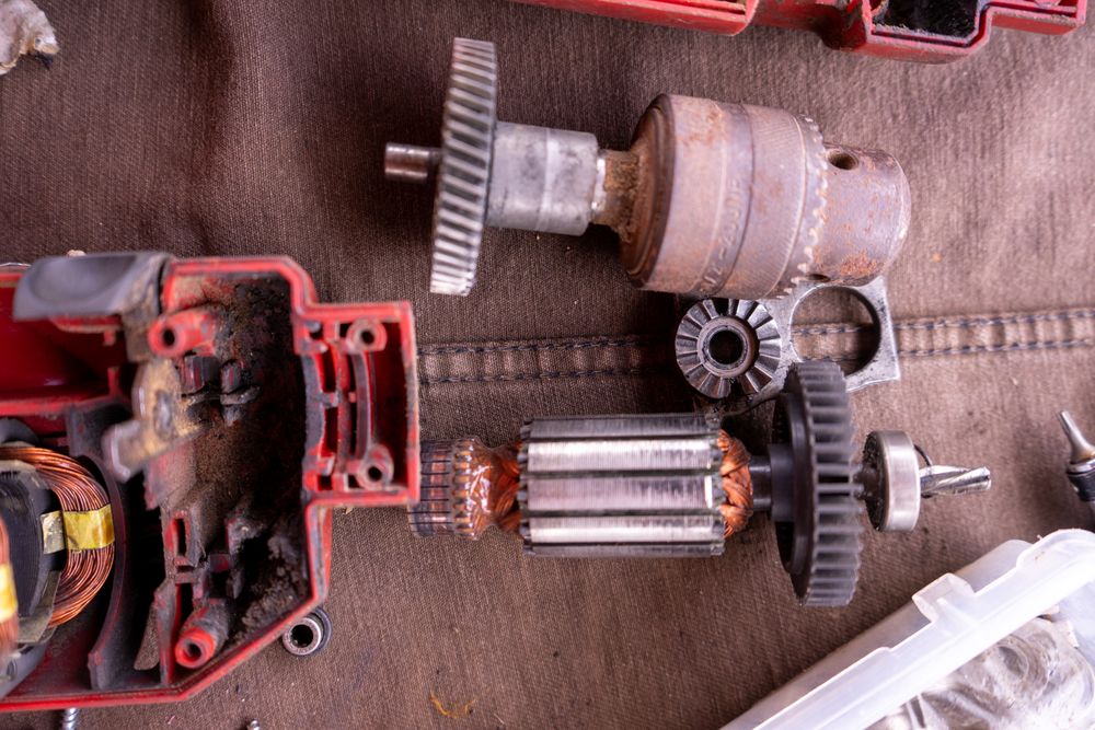Tools and engine parts on brown fabric