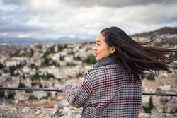 Cheerful woman visiting ancient city