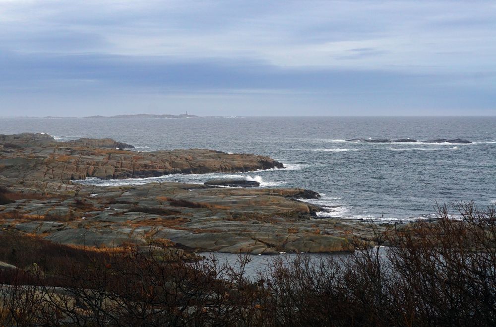 Rocky seashore and dark wavy sea in dusk