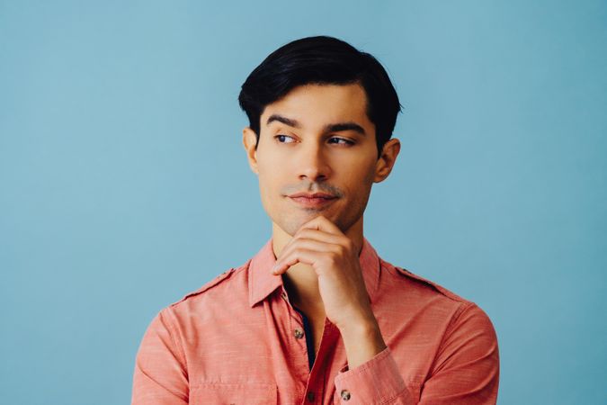 Portrait of curious Hispanic male looking to the side