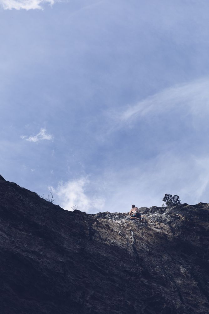 Anonymous man climbing rock
