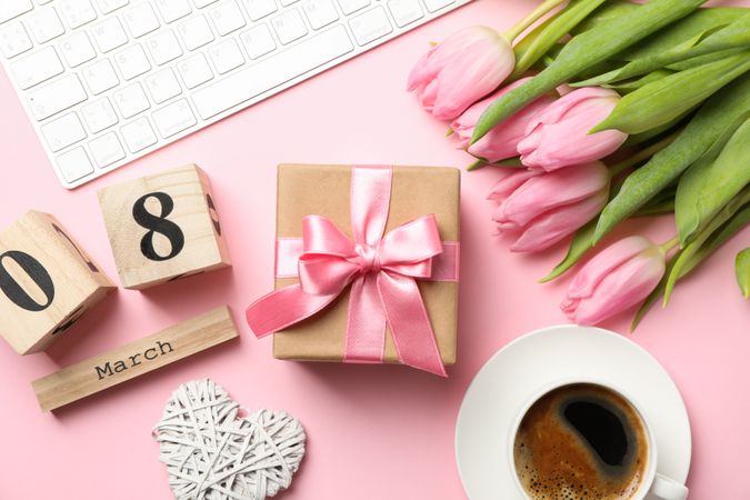 Composition with tulips and gift on pink background, top view