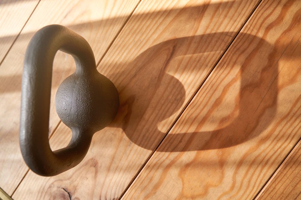 Metal kettlebell on wooden floor
