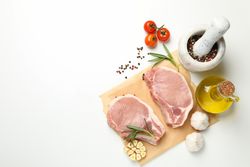 Composition with raw meat and ingredients on light background, top view