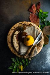 Top view of rustic autumnal table setting with mini squash and leaves 4mXpX5