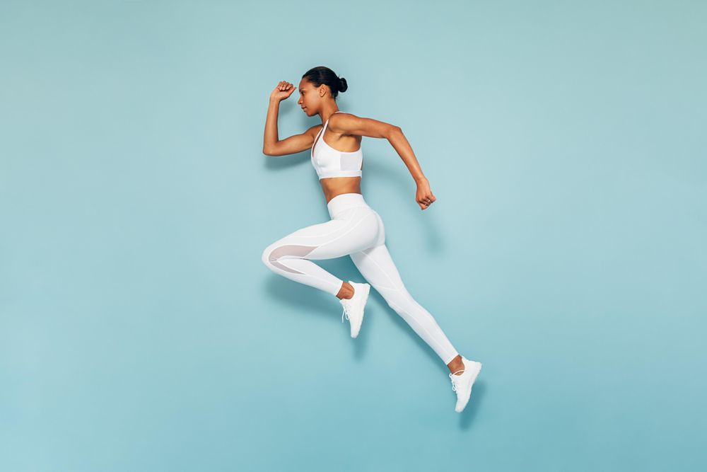 Sports woman running in studio