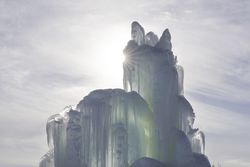 Sun rays shining through a blue ice structure
