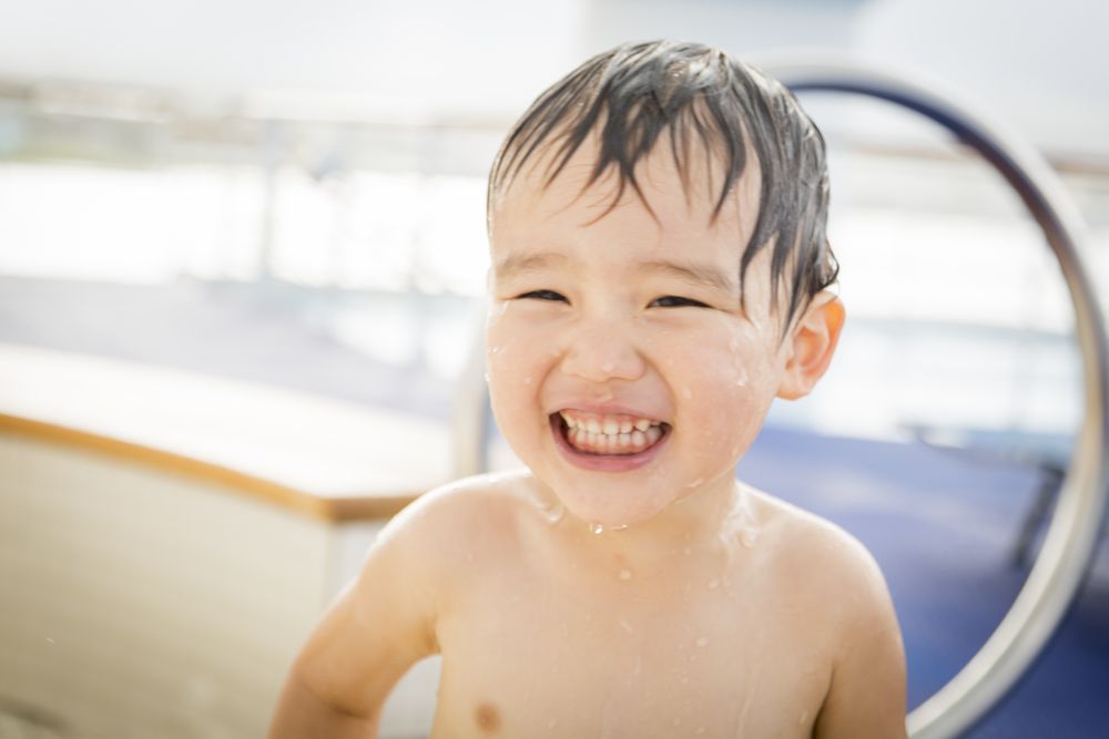 Biracial Boy Smiling and Having Fun at the Water Park