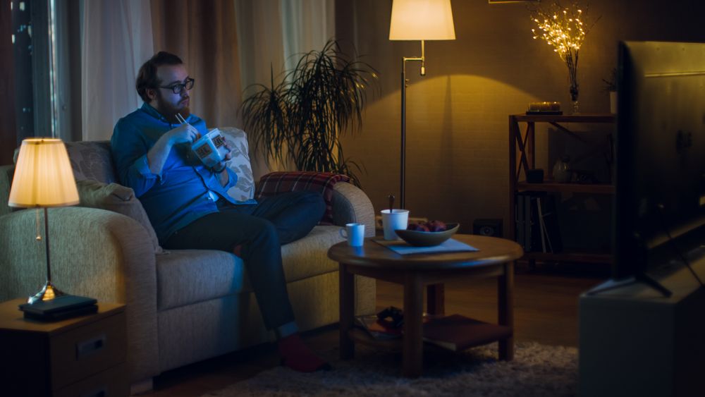 In the Evening Man Sitting on a Couch In His Living Room.