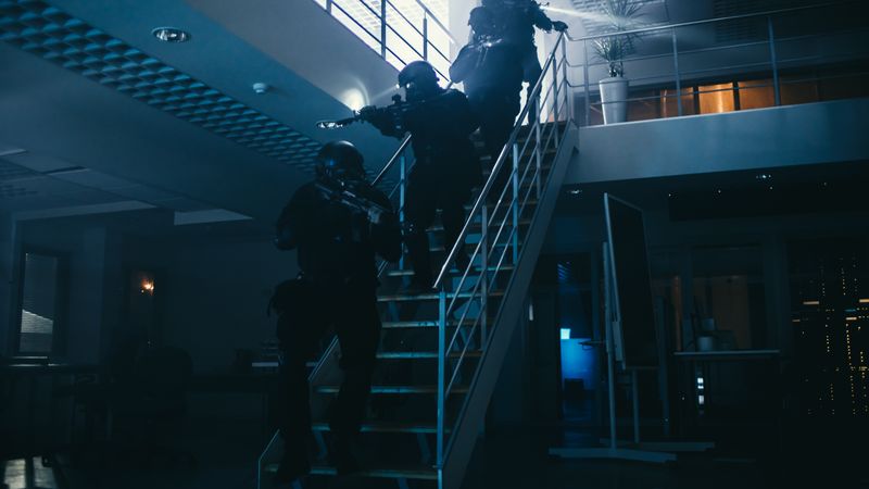Soldiers with Rifles and Flashlights Move Forwards and Cover Surroundings.