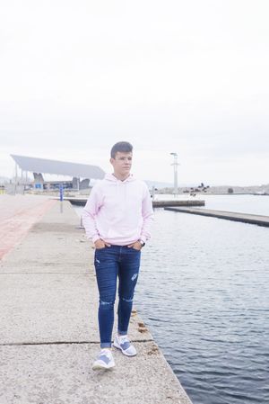 Young teenager walking on promenade while looking away