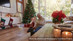 Mature man giving high five to his granddaughter at home 5kRvDL