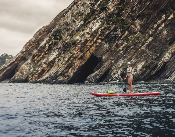 Woman on paddleboard floating in sea