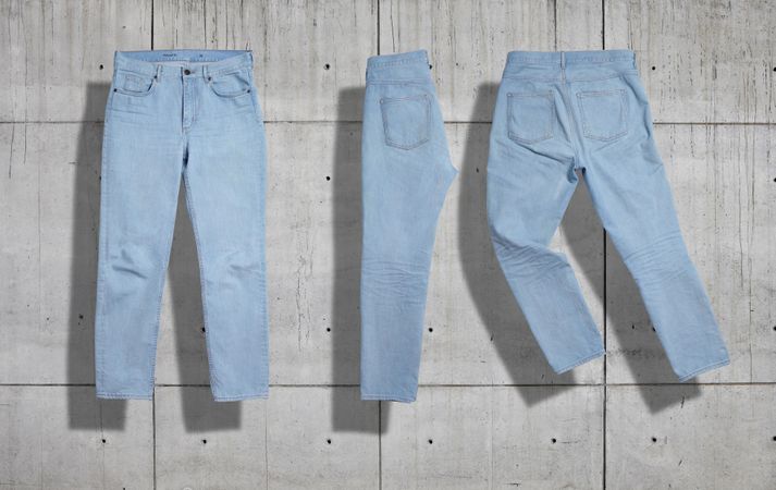 Blue jeans set on concrete