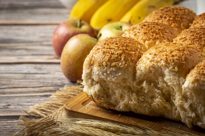 Breakfast table with coconut bread and fruits.