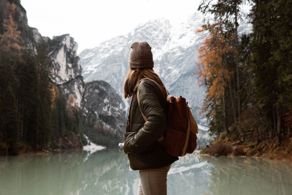 Woman delighting in views near lake and mountains