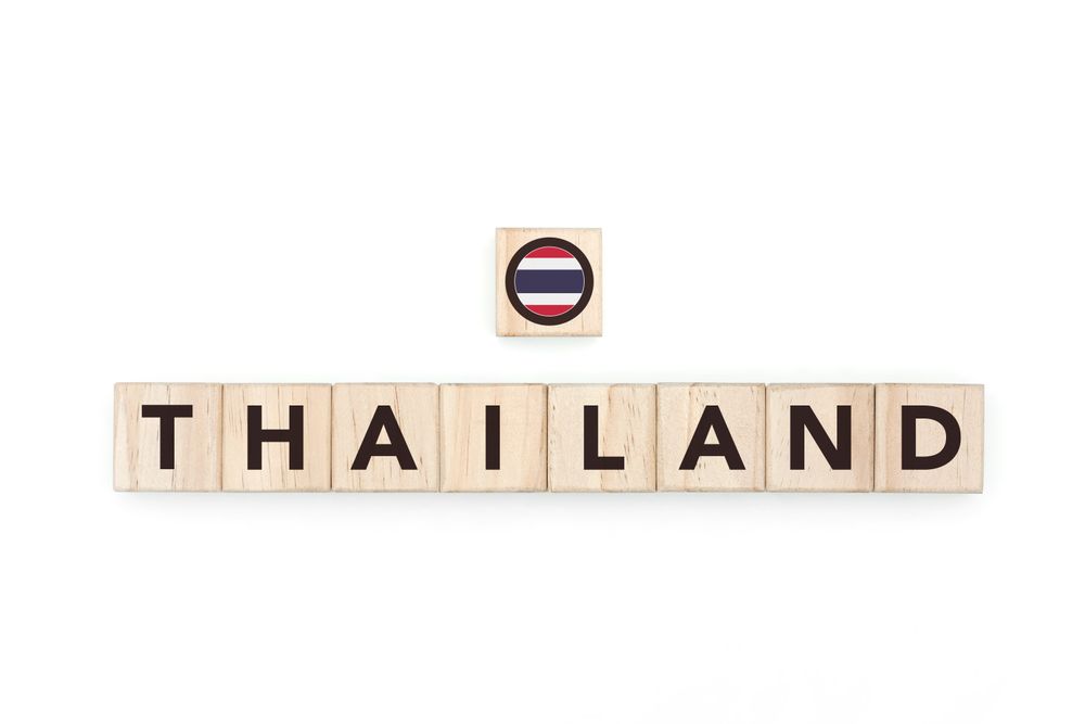 Wooden blocks bearing the name and flag of Thailand. Thai and Southeast Asian Culture, national identity, travel, and geography in a copy space design.