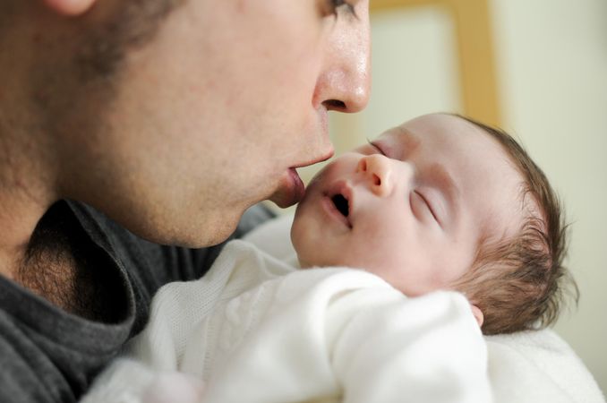 Father kissing infant