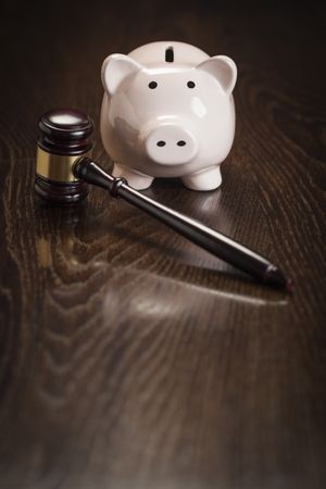 Gavel and Piggy Bank on Table