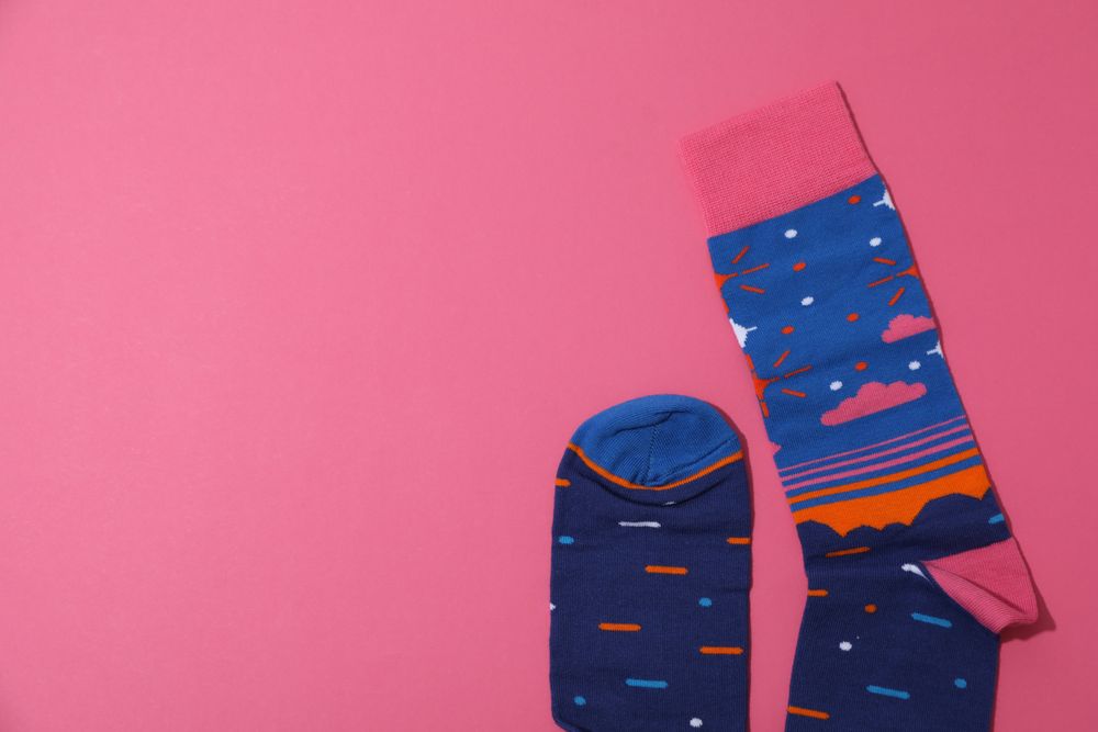 Casual clothes and wearing concept - socks, clothes for foot