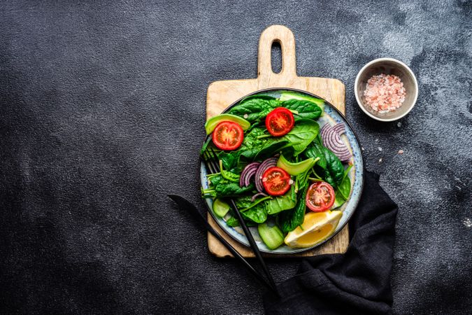 Top view of spinach salad with cherry tomatoes and cucumber