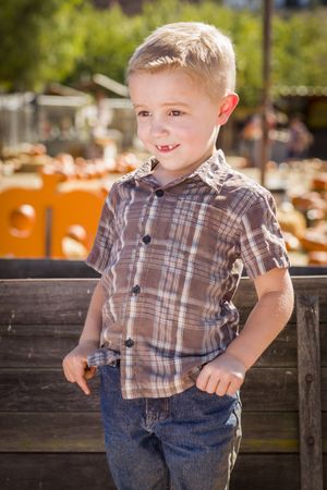 Little Boy With Hands in His Pockets at Pumpkin Patch.
