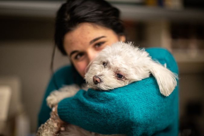 Woman hugging dog indoor