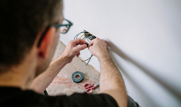 Electrician working on the electrical installation of a house