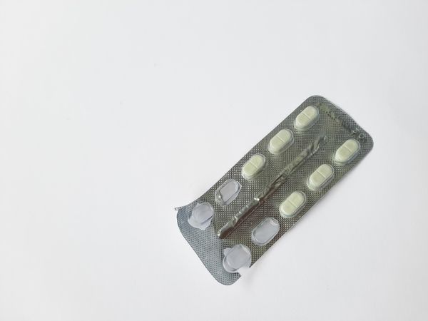 Partially Used White Tablet Medicine in Blister Pack Isolated on Plain Background