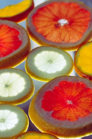 Sliced citrus fruits against light