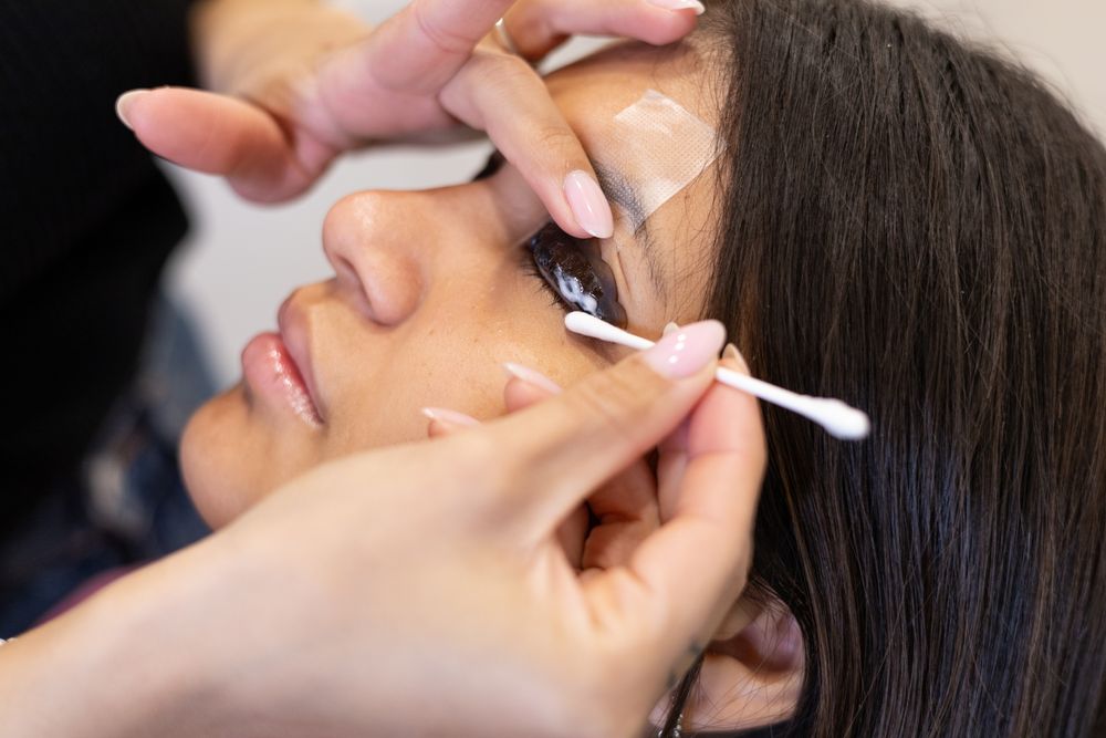 Beautician making eyelash lamination and dyeing procedures