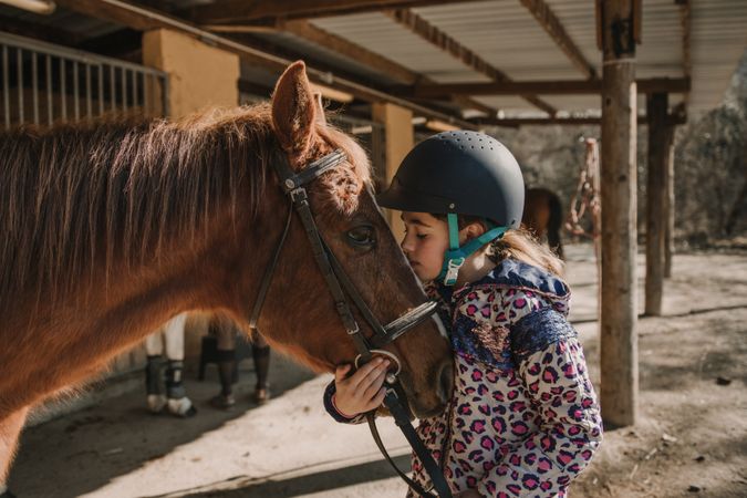 Girl kissing a horse