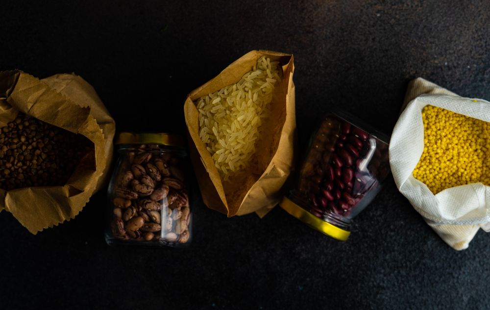 Top view of variety of dried pantry items on kitchen counter