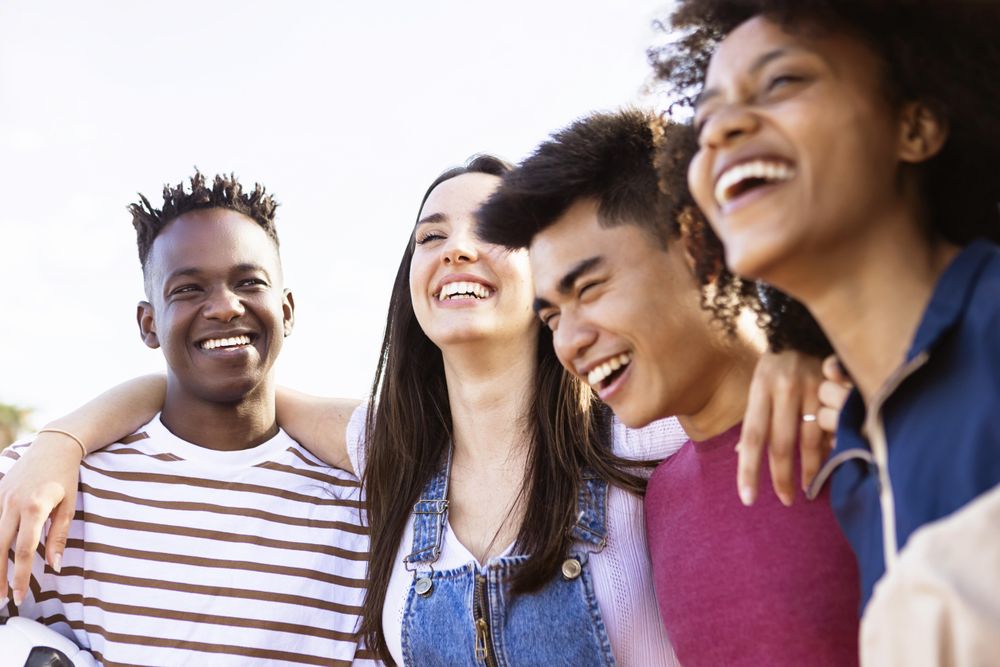 United multiethnic friends laughing and having fun together outdoors