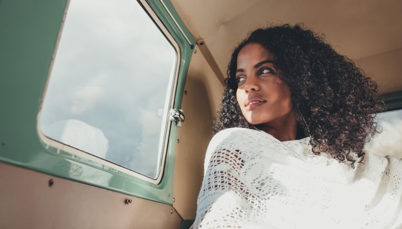 Black woman on road trip traveling in a van