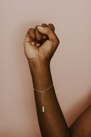 Black woman wearing a gold bracelet