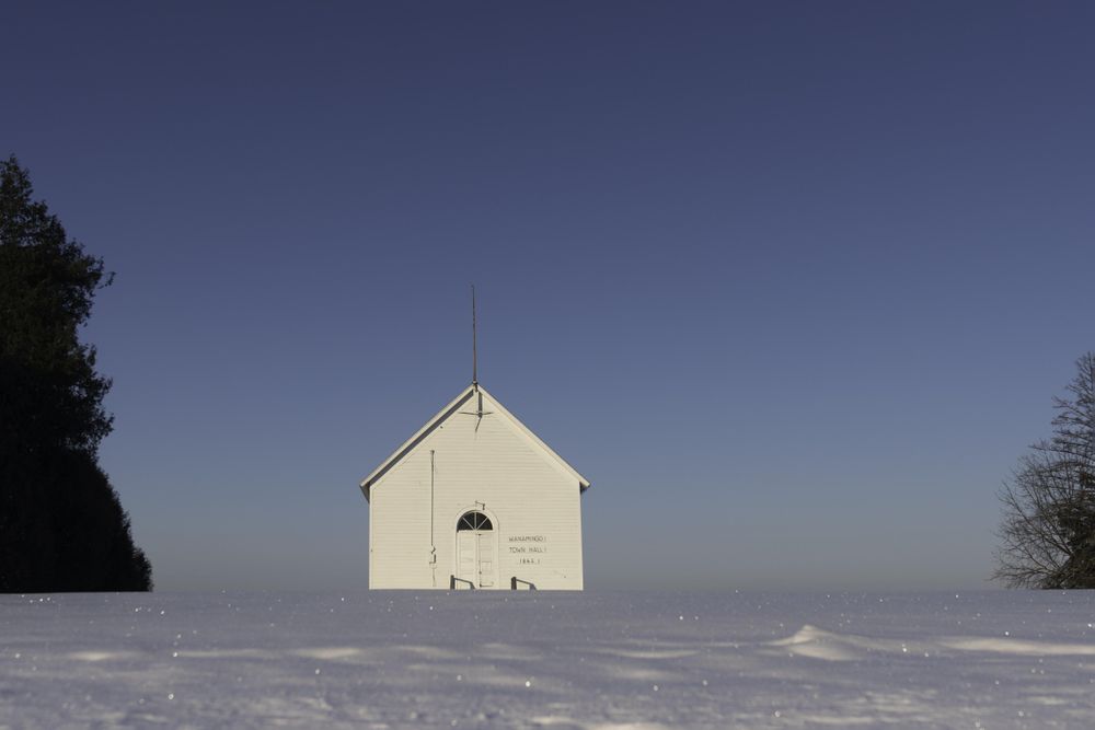 A rural town hall in a snowy field