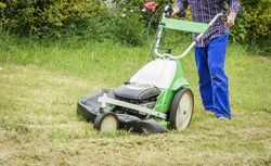 man mowing the lawn with a lawnmower
