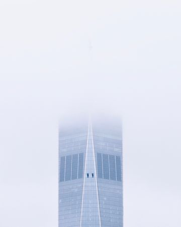 Skyscraper surrounded by clouds