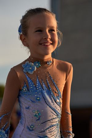 Cheerful girl in leotard on street