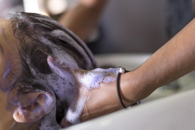 Head of female being washed in salon